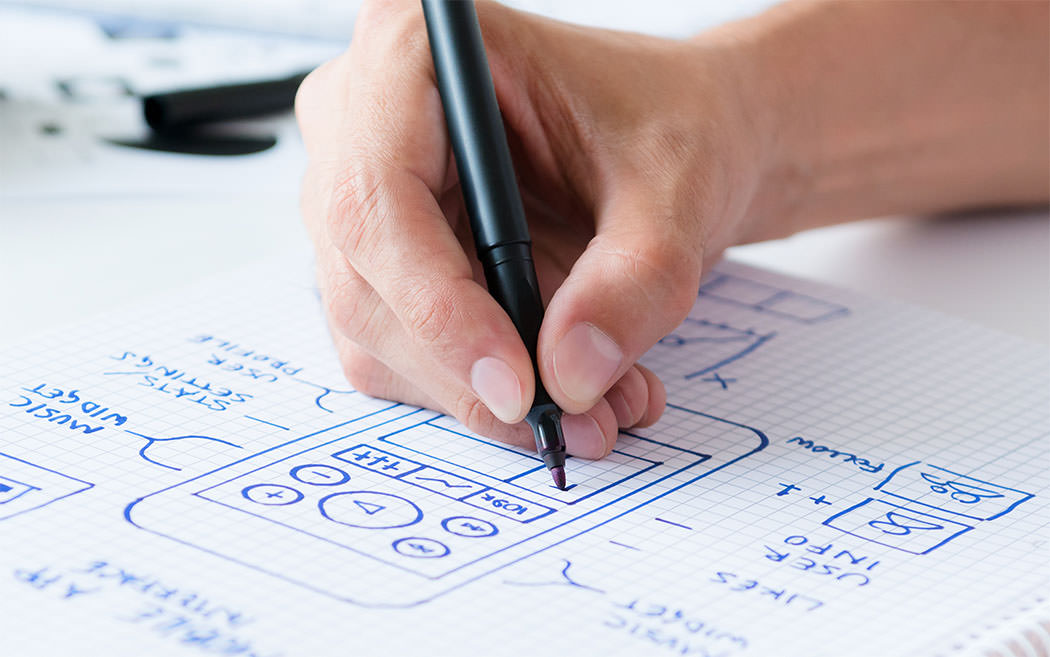 Person using a marker to sketch a design for a new app.